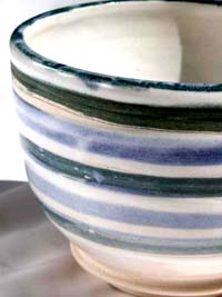 White bowl with green and blue stripes